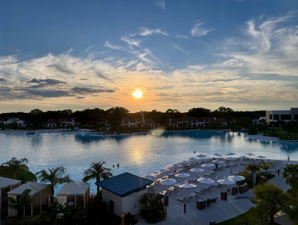 Image of sunset from balcony accommodations at Evermore Resort over Evermore Bay