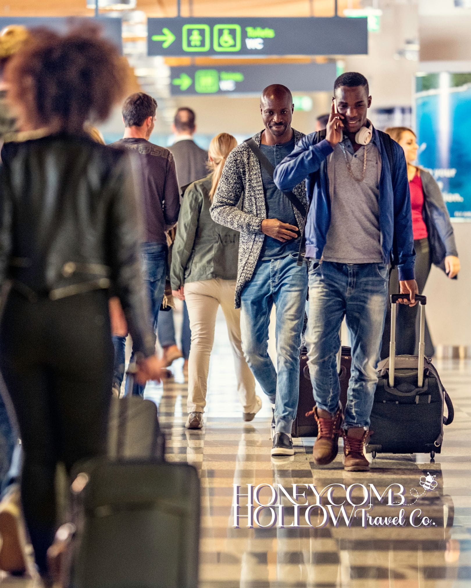 Travelers walking through a busy airport terminal with rolling luggage, illustrating stress-free travel planning and smooth airport navigation.